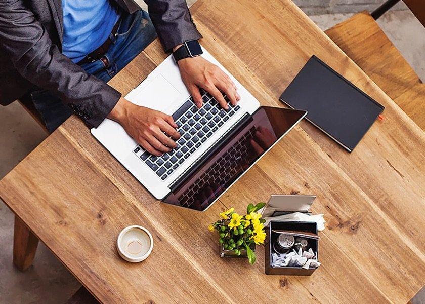 man on laptop at coffee shop