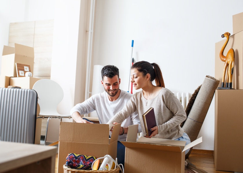 two people packing things in boxes